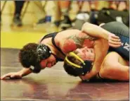  ?? MORNING JOURNAL FILE ?? Lorain’s Aaron Huff, shown here with a hold on North Ridgeville’s Sam Reece, has recently returned to wrestling after recovering from football injuries.