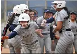  ?? WILL LESTER — STAFF PHOTOGRAPH­ER ?? Aquinas’ Amani Mcfield, left, celebrates with teammates as she approaches home plate after hitting a two-run home run during Monday’s game.