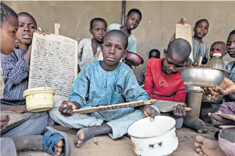  ??  ?? Ousman Habib, top left, has 300 children aged five to 15 in his care at a madrassa in Maiduguri, northern Nigeria. The school teaches children the Koran and has to send them out to beg for their survival