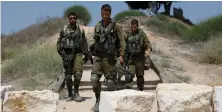  ?? (Amir Cohen/Reuters) ?? SOLDIERS WALK near Sderot last month.