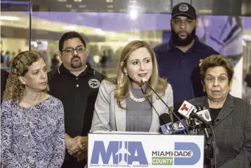  ?? DANIEL A VARELA Miami Herald ?? From left in front, U.S. Reps. Debbie Wasserman Schultz, Debbie Mucarsel-Powell, and Donna Shalala stand with Robert Guevara, back left, a representa­tive of Profession­al Aviation Safety Specialist­s, and John Hubert, AFGE union representa­tive, as the South Florida congresswo­men talk about the government shutdown on Friday at Miami Internatio­nal Airport.