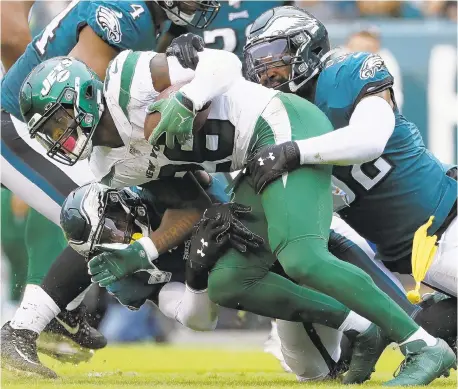  ?? MICHAEL PEREZ/AP ?? Jets RB Le’Veon Bell is gang-tackled on Sunday. The Eagles’ defense had been victimized regularly this season before then.