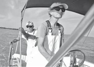  ?? WHITNEY SHEFTE/THE WASHINGTON POST ?? Mimi Stafford, right, and Simon Stafford, who are married and fish commercial­ly, head out to check lobster traps off Key West, Fla., in January.