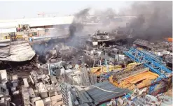  ??  ?? Fire engulfs a 1,000-square-meter site in Amghara.