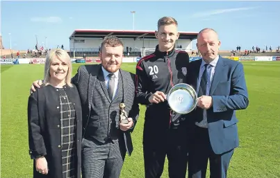  ?? Pictures: Graham H Black. ?? Above: George Baird presents Thomas O’ Brien with the Geordie Baird Memorial Trophy as the manager’s player of the year. Also pictured are Linda and Reece Baird. Below: Angus Nairn’s widow Zena and her daughter Audrey present Blair Yule with his trophy.