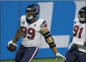  ?? DUANE BURLESON — THE ASSOCIATED PRESS ?? Texans defensive end J.J. Watt runs into the end zone after returning an intercepti­on 19 yards against the Lions.