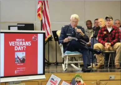  ?? CHARLES PRITCHARD — ONEIDA DAILY DISPATCH ?? Colonel Clark Speicher reads to the students of E A McAllister Elementary School about the meaning of Veterans Day on Tuesday, Nov. 6, 2018.