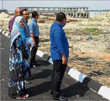  ??  ?? Better facilities: Hamzah showing the upgrading works being carried out at the Bagan Datoh