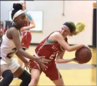  ?? PETE BANNAN — MEDIANEWS GROUP ?? West Chester East’s Alex Douglass avoids the defense of Strath Haven’s Faith Raymond in the first half Tuesday night.