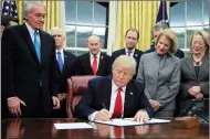  ?? AP PHOTO MANUEL BALCE CENETA ?? President Donald Trump signs into law the bipartisan Interdict Act to curtail opioids traffickin­g, during a ceremony in the Oval Office of the White House in Washington, Wednesday, Jan. 10, 2018. A fever of speculatio­n has broken out about whether U.S....