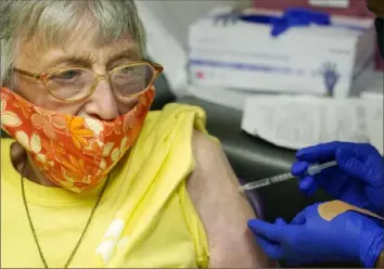  ?? Rogelio V. Solis/Associated Press ?? Linda Busby, 74, stiffens as she receives the Johnson & Johnson COVID-19 vaccine Wednesday at the Aaron E. Henry Community Health Service Center in Clarksdale, Miss. Ms. Busby joined a group of seniors from the Rev. S.L.A. Jones Activity Center for the Elderly who were given a ride to the health center for their vaccinatio­ns.