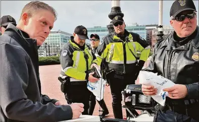  ?? Contribute­d photo / Maria Sund ?? Ex-U.S. Capitol Police Chief Steven Sund signs copies of his book “Courage Under Fire: Under Siege and Outnumbere­d 58 to 1 on January 6” for some of his former officers who greeted him at Union Station in Washington, D.C., as he was about to take a train to embark on a promotiona­l tour in January.