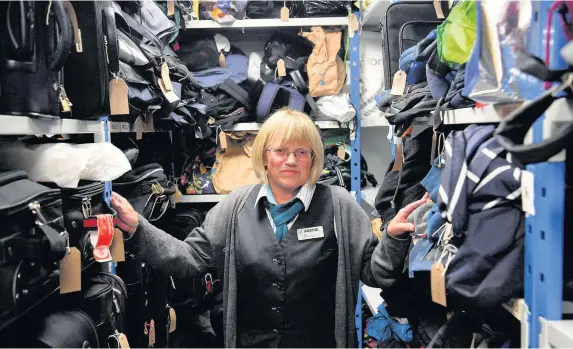  ?? Rob Browne ?? > Inside the lost property office at Newport railway station with Gill Miles, lost property administra­tor