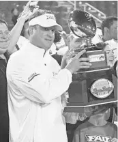  ?? JIM RASSOL/STAFF PHOTOGRAPH­ER ?? Florida Atlantic coach Lane Kiffin holds the trophy after the team’s victory over Akron last season in the Boca Raton Bowl. FAU returns 10 starters from the 11-3 club.