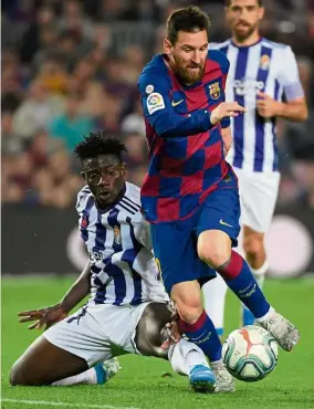  ?? — AFP ?? Too rough: Barcelona’s Lionel Messi is tackled by Real Valladolid’s Mohammed Salisu during the La Liga match at the Nou Camp on Tuesday.