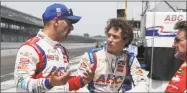  ?? Michael Conroy / Associated Press ?? Tony Kanaan left, talks with teammate Matt Leist, center, during a practice session on May 17.