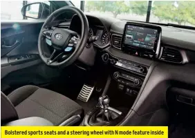  ??  ?? Bolstered sports seats and a steering wheel with N mode feature inside
