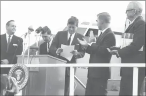  ?? (Special to the Democrat-Gazette) ?? Gov. Orval Faubus (left) looks on as President John F. Kennedy accepts the deed to the Fort Smith National Historic Site during a stop at the Fort Smith airport on Oct. 29, 1961. In March 1963, Faubus claimed that Kennedy “left Arkansas boys to die” after being shot down during the Bay of Pigs invasion of Cuba, but Kennedy revealed in recordings that Arkansans had trained Cuban exiles, not fought with them.