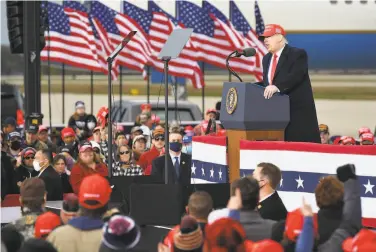  ?? Mandel Ngan / AFP / Getty Images ?? President Trump addresses his supporters at a campaign rally at the airport in Muskegon, Mich.