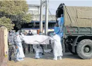  ?? REUTERS ?? The body of a victim of the plane crash in Pokhara is loaded into a vehicle bound for Kathmandu yesterday.