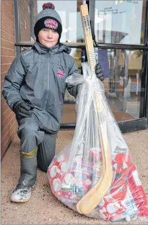  ?? COLIN MACLEAN/JOURNAL PIONEER ?? Greenfield Elementary School student Max Clark is one of a number of students at the school who spent some of their own savings to help with the annual Christmas hampers campaign. Greenfield has partnered with the St. Eleanors Lions Club to sponsor 15 families.