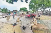  ??  ?? Police at Vikas Dubey’s demolished house in Kanpur last week.