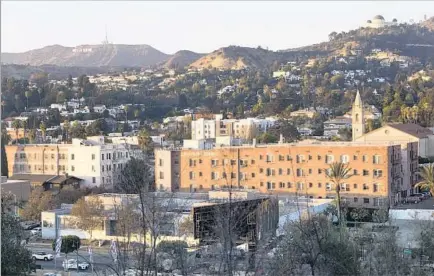  ?? Photograph­s by Calvin B. Alagot Los Angeles Times ?? CLOCKWISE FROM MID-PAGE, stairs lead to the art center at Barnsdall Art Park in East Hollywood; Kimberly Hamilton hula hoops at the park; the view to the north of the park includes the Hollywood sign and the Griffith Park Observator­y in the distance.