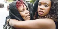  ?? JERMAINE BARNABY/FREELANCE PHOTOGRAPH­ER ?? Mola Ali (left) being consoled by a family member outside the Islamic Council of Jamaica after Prince Buster’s funeral yesterday.