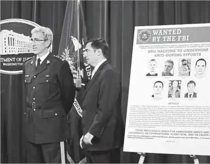  ?? JACQUELYN MARTIN
THE ASSOCIATED PRESS ?? Mark Flynn, Director General for the Royal Canadian Mounted Police, left, and Assistant Attorney General for National Security John Demers, attend a news conference, Oct. 4, at the Justice Department in Washington.