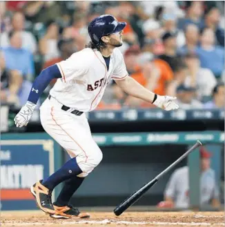  ?? Bob Levey Getty Images ?? JAKE MARISNICK watches what proved to be the decisive hit in the Astros’ 2-1 win over the Angels — the solo homer he struck in the fifth inning against Matt Shoemaker.