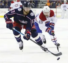  ?? Jay LaPrete/the associated Press ?? Columbus Blue Jackets’ Brandon Dubinsky, left, tries to keep the puck away from Montreal Canadiens’ Jordan Weal during the first period of their game Thursday in Columbus, Ohio.