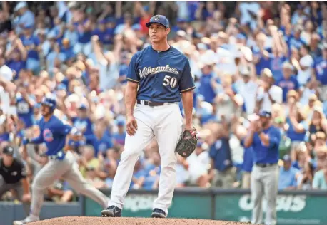  ?? BENNY SIEU / USA TODAY SPORTS ?? Brewers pitcher Jacob Barnes looks on after giving up a solo home run to Cubs third baseman Kris Bryant in the eighth inning.