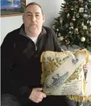  ?? | NEIL STEINBERG/ SUN- TIMES PHOTOS ?? Rick Martinotti holds a pillow that his uncle, Marine Cpl. Stanley Swiontek, gave to Swiontek’s mother on Mother’s Day in 1941.