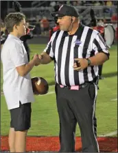  ?? LARRY GREESON / Staff ?? Calhoun/Gordon County Junior Mayor Tripp Morrison presented the officials with the game ball for the SHS versus CHS game on Friday, Oct. 9.