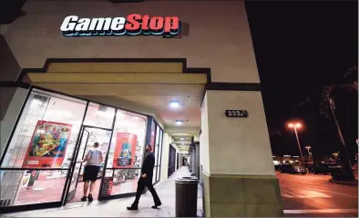  ?? FREDERIC J. BROWN / AFP via Getty Images ?? People enter a GameStop store in Alhambra, California on Jan 27. In response to stock market volatility surroundin­g companies such as GameStop, Greenwich-based brokerage Interactiv­e Brokers Group announced what would turn out to be short-lived trading restrictio­ns affecting stocks and options of GameStop and several other companies.