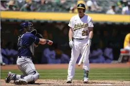  ?? JEFF CHIU — THE ASSOCIATED PRESS ?? The A's Sheldon Neuse (26) reacts after striking out as Tampa Bay Rays catcher Mike Zunino throws the ball back to the pitcher during the fourth inning in Oakland Wednesday.