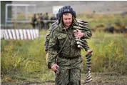  ?? ASSOCIATED PRESS ?? Recruits carry ammunition during a military training at a firing range in the Rostov-on-Don region in southern Russia, on Tuesday.