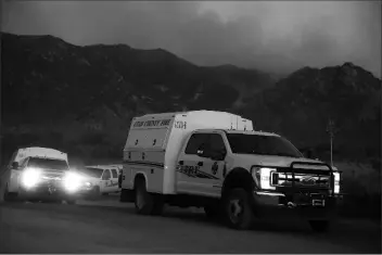  ?? ASSOCIATED PRESS ?? FIRES CREWS MOVE TO another location as they battle the Bighorn Fire along the western side of the Santa Catalina Mountains on Sunday in Oro Valley.