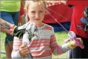  ?? KRISTI GARABRANDT — THE NEWS-HERALD ?? Parker Warmington, 6, of Chardon, holds the catfish she caught while fishing at the First Bite Fish Tanks at the Lake County Fair July 26.