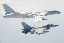  ??  ?? A Taiwanese F-16 fighter jet flying next to a Chinese H-6 bomber (top) in Taiwan’s airspace.
