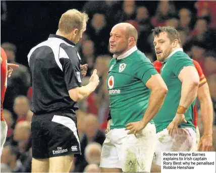  ??  ?? Referee Wayne Barnes explains to Irish captain Rory Best why he penalised Robbie Henshaw