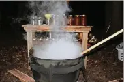  ?? CONTRIBUTE­D ?? The Yoders make homemade chili soup in a big castiron kettle over an open fire. The chili is then canned for consumptio­n later and also enjoyed on the spot.