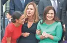 ?? JACK GRUBER/USA TODAY ?? House members Alexandria Ocasio-Cortez, D-N.Y., left; Debbie Mucarsel-Powell, D-Fla., center; and Abby Finkenauer, D-Iowa, huddle outside the U.S. Capitol for a class photo.