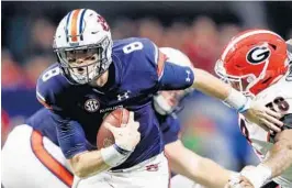  ?? JAMIE SQUIRE/GETTY IMAGES ?? Auburn quarterbac­k Jarrett Stidham, left, is quiet but has still emerged as the Tigers’ team leader. He leads Auburn against UCF today in the Peach Bowl.