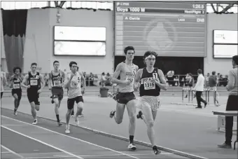  ?? PHOTO COURTESY OF SUSAN HAMMOND ?? Stonington’s Rhys Hammond leads the field during Saturday’s 1,000-meter race at the New England indoor track and field championsh­ips in Boston. Hammond broke his own school record and won the race.