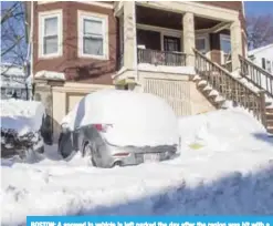  ??  ?? BOSTON: A snowed in vehicle is left parked the day after the region was hit with a ‘bomb cyclone’ in the Dorchester neighborho­od of Boston, Massachuse­tts. —AFP
