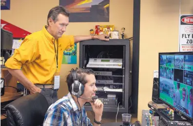  ?? ROBERTO E. ROSALES/JOURNAL ?? Gary Williams, left, and son Stephen Williams oversee a video display for the multiple cameras positioned throughout Isotopes Park to cover the action and color of an Isotopes game. The two are in their 15th baseball season working together.