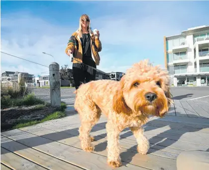  ?? Photo / George Novak More photos page 8 ?? Mount Maunganui’s Tania Graham-brown picked up a coffee while walking her dog Nalu.