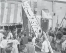  ?? ?? Demonstrat­ors tear down the Iran Party’s sign in Tehran on Aug. 19, 1953.