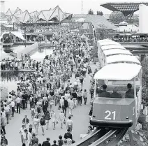  ?? GORDON BECK/FILES ?? The Monorail runs past the crowd en route to the Canadian pavilion, back right, at Expo 67.